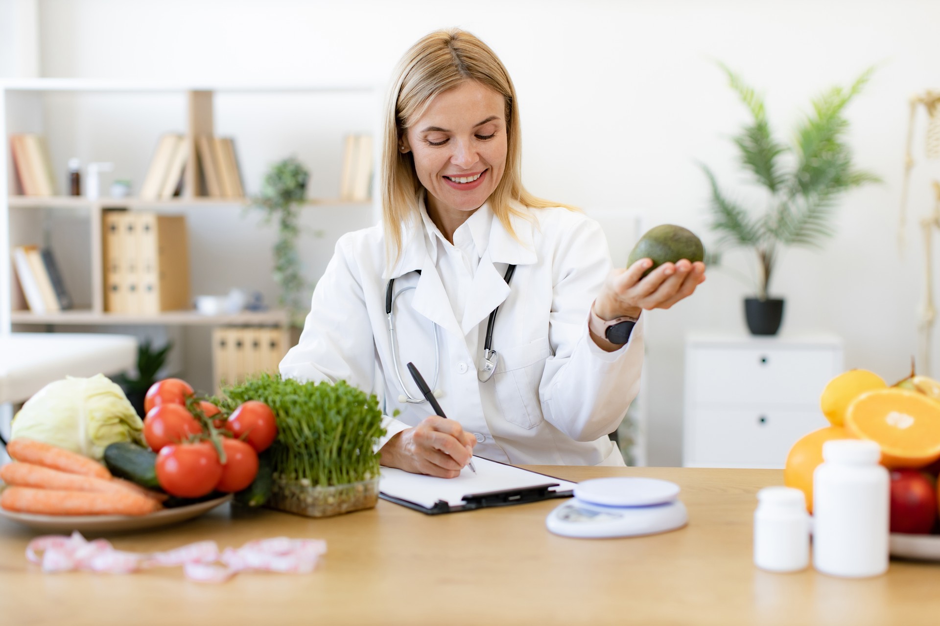 Happy female writing prescription for patients proper healthy diet.