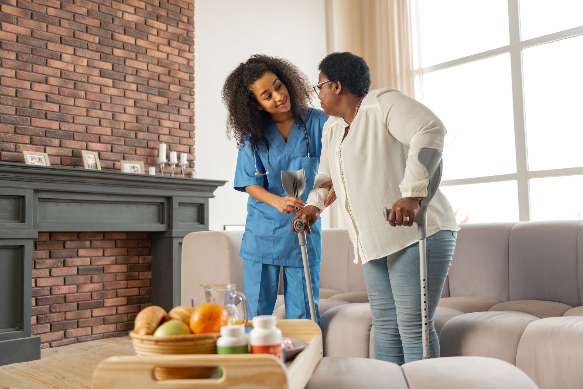 Assisting medical attendant of hospital helping woman to walk